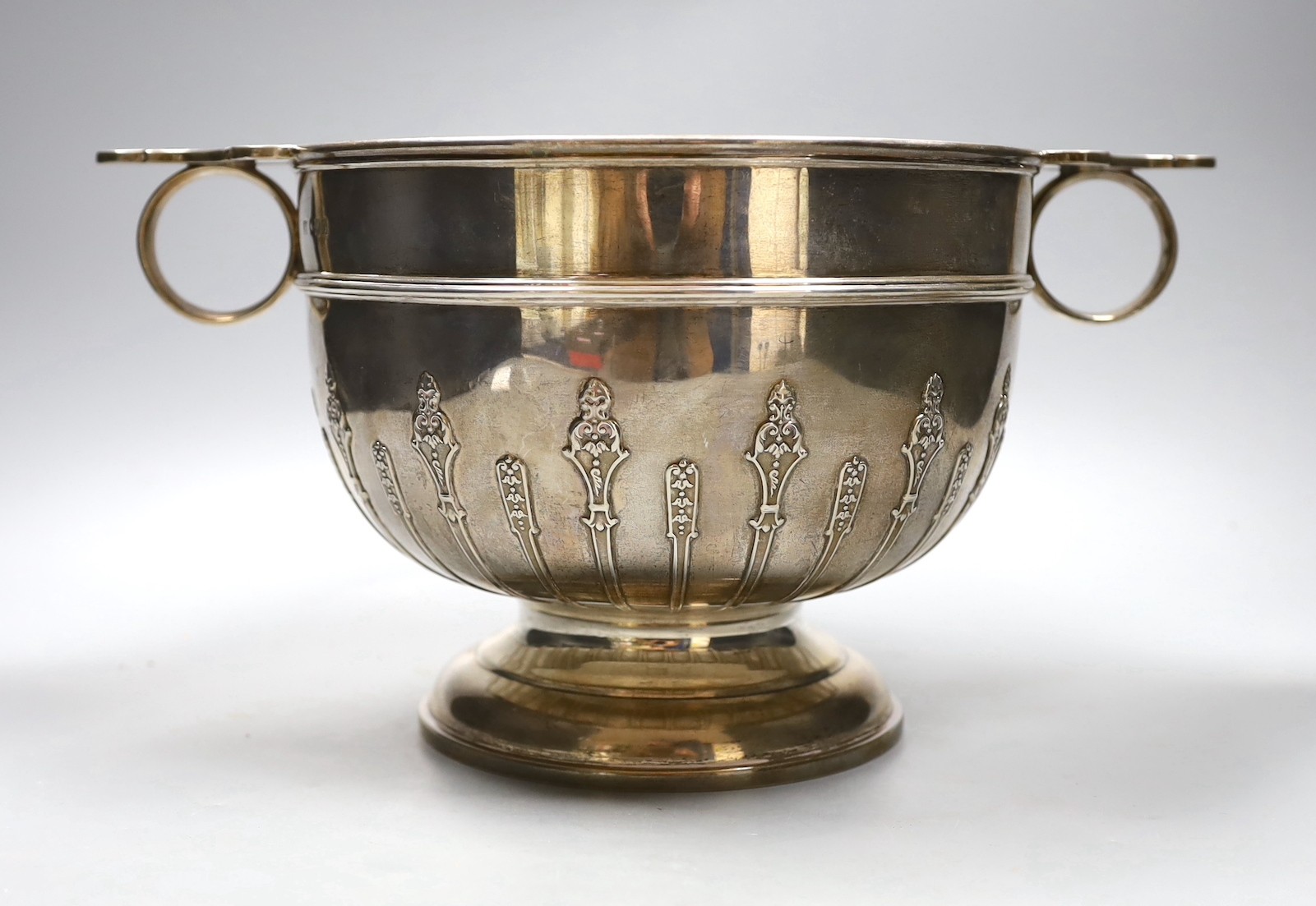 A late Victorian two handled silver rose bowl, with strapwork decoration and later presentation inscription, London 1900, 1532 grams, 35cm over handles, height 18cm